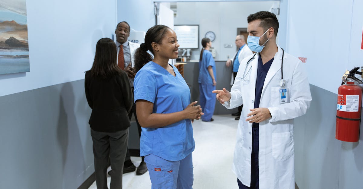 Doctors and nurses in a hospital hallway discussing medical matters.